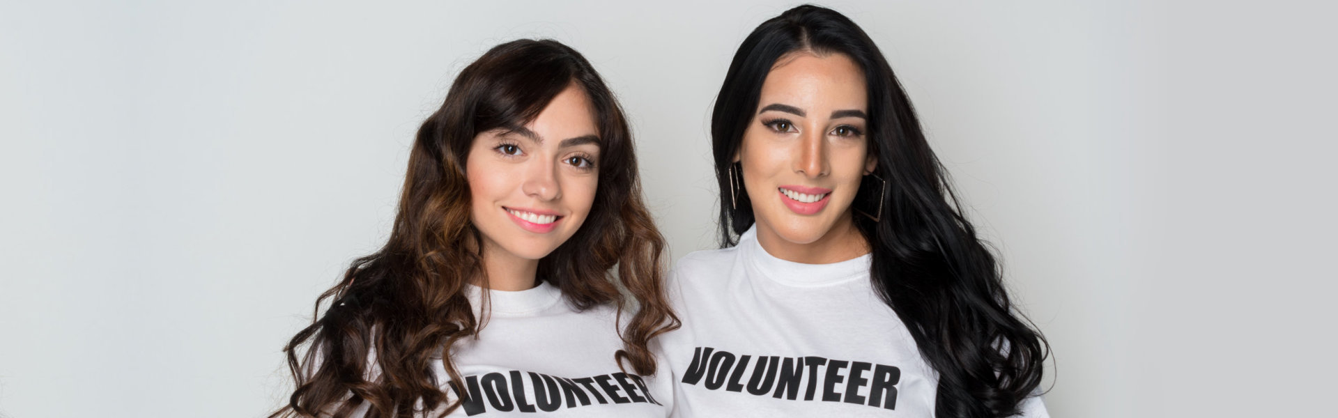 two volunteer smiling